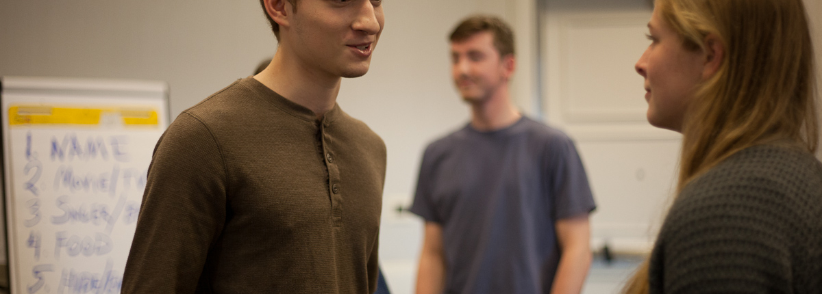 Three people are talking in a room.