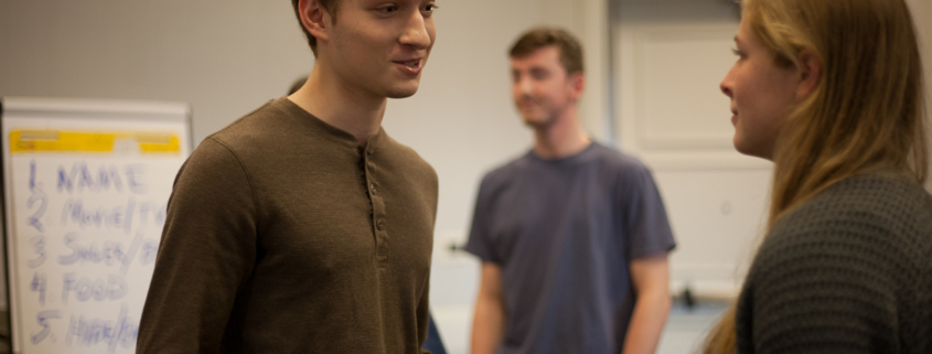 Three people are talking in a room.